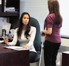 a visually impaired woman talking to another woman in an office